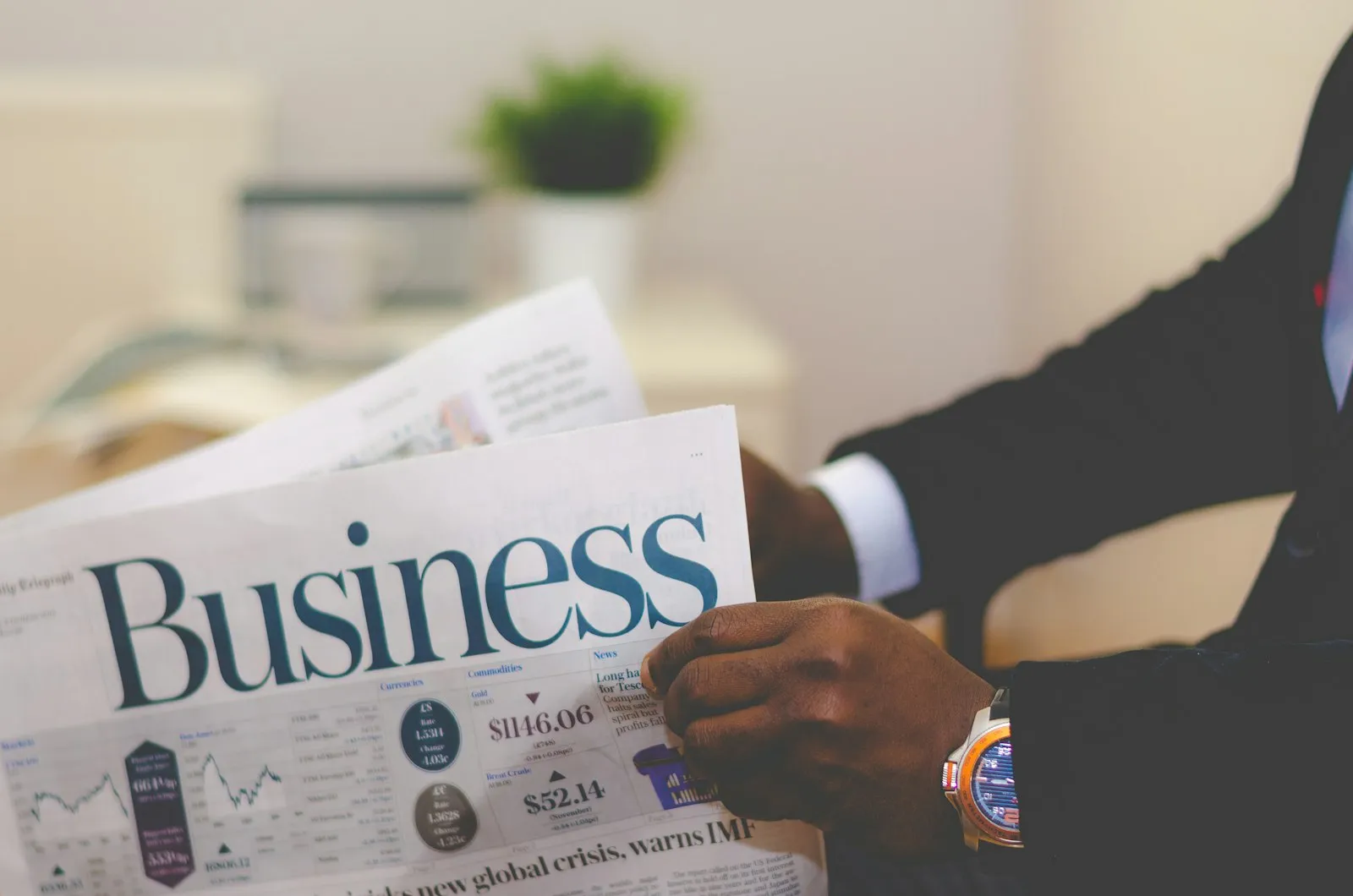 A business newspaper with financial charts and figures