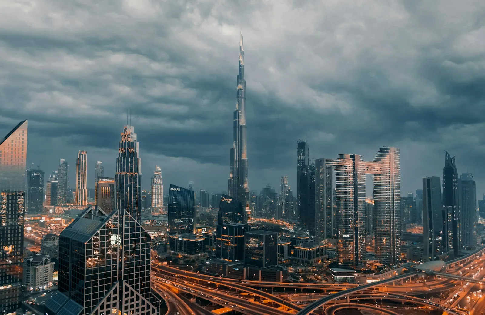 The Burj Khalifa and Downtown Dubai skyline under dramatic storm clouds