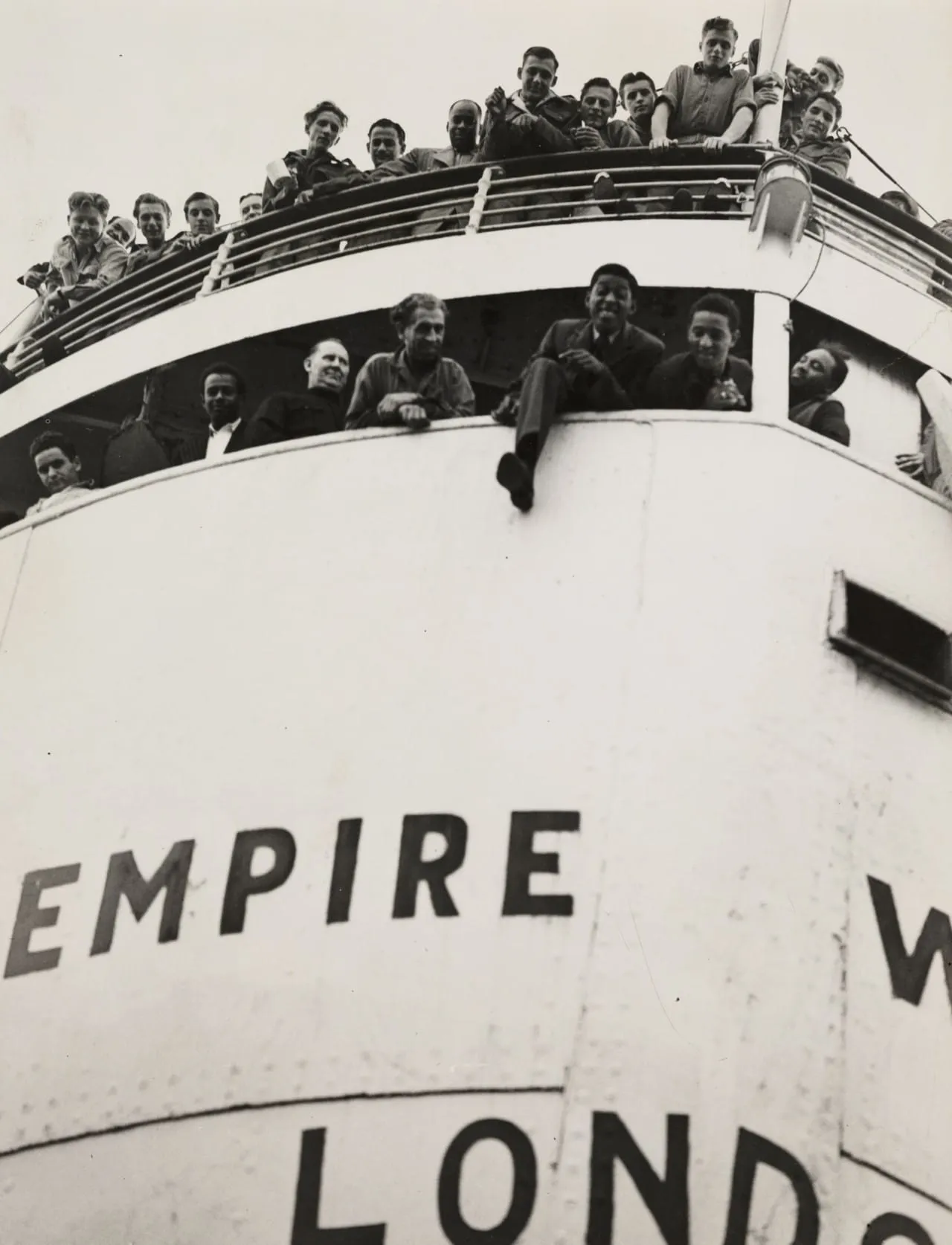 Passengers on the bow of the Empire Windrush